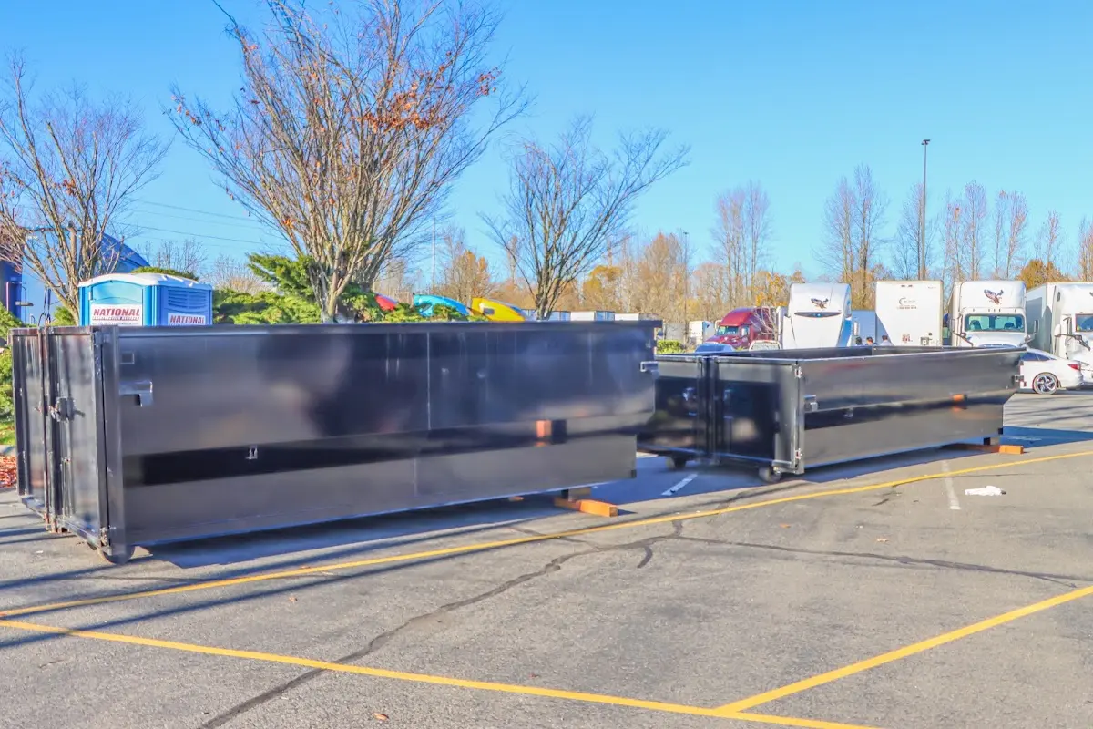 Professional dumpster rental service with roll-off container on residential driveway in Chesapeake Ranch Estates